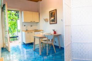 a kitchen with a table and a sink and a table at Al Cedro Terrazza sul Monferrato con Idromassaggio in Grazzano Badoglio