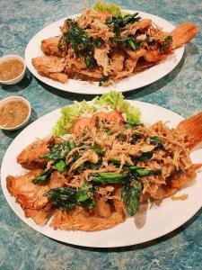 จอมเมือง Motel في نان: طبقين من الطعام فوق طاولة
