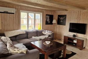 a living room with a couch and a coffee table at Trevliga stugor i Torhamn, perfekt för familjer in Karlskrona