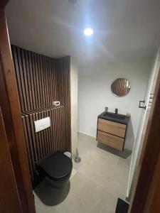 a bathroom with a black toilet and a sink at Piscadera bay resort 15c in Willemstad