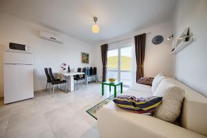 a living room with a white couch and a table at Apartments Ladesta in Lastovo