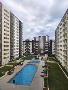 an overhead view of an apartment complex with two swimming pools at New Cute&Cozy Fully Furnished Studio - Avida Tower 2 - 100 Mbps wifi in Iloilo City