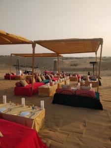a group of tables in the sand in the desert at Desert Camps Heritage Jaisalmer in Jaisalmer