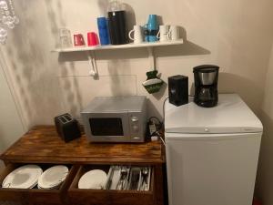 a microwave sitting on top of a counter next to a refrigerator at Dobbeltrom in Moss