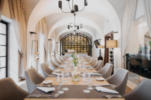a long dining room with a long table and chairs at Mamaison Le Regina Boutique Hotel in Warsaw