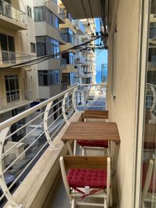 two tables and chairs on a balcony of a building at Side SeaView 3Bedrooms Apartment Sliema steps from Promenade and Sliema Ferry in Sliema