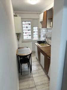 a small kitchen with a small table and a table at Casa Darius 2 in Alexandria