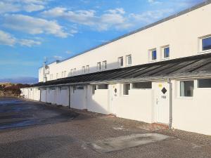 a large white building with a row of doors at 6 person holiday home in Brovst-By Traum in Brovst