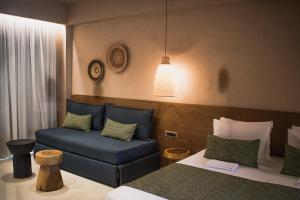 a living room with a couch and a chair at Panorama Hotel in Falasarna +37 photos