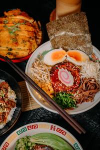 a table with plates of food with eggs and noodles at ICON Venue and Suites in General Santos