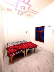 a bed in a room with a ceiling at Kumkum paying guest house in Ayodhya