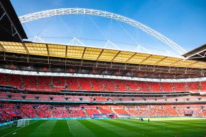 a view of a soccer stadium with red seats at Modern Flat 5 Min From Wembley Stadium 30 Min From London in London