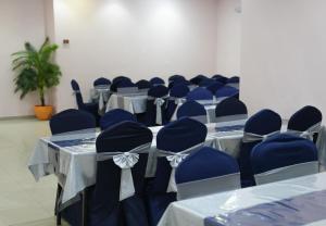 a room with blue tables and chairs with blue chairs at Diyar Al Deafah Hotel in Mecca
