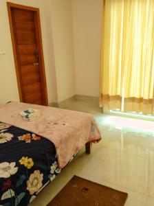 a small bedroom with a bed and a window at Hasnahena 1/F,Dhaka Gurdren City,Adabar,Mohammadpur in Dhaka