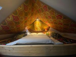 a bedroom with a bed with a fish wall at Tailor's Trail gîte d'adventure Beaufort Mullerthal in Beaufort