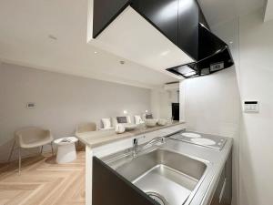 a kitchen with a sink and a counter top at b hotel Rijodori - City Central Studio Stay with Breakfast in Hiroshima +19 photos