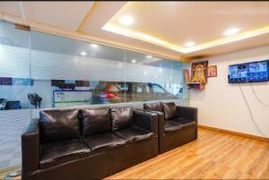 un soggiorno con divano e TV di Hotel Raj vihar residency a Vijayawāda