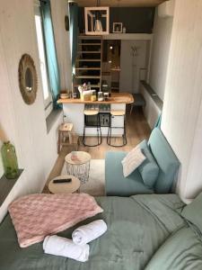 a small living room with a couch and a table at Lumineux studio sous les toits de Menton in Menton