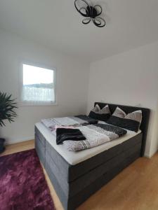 een bed in een kamer met een plafondventilator bij Casa Tara in Döbriach