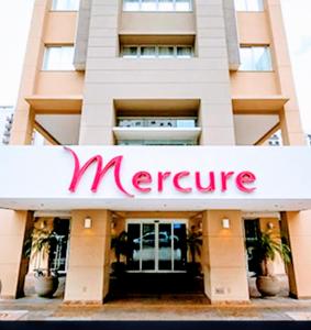 a large building with a merge sign on it at Hotel M-RCURE Vila Olímpia - The Urban Duplex Studio - Red Velvet Deluxe Edition - By LuXXoR in Sao Paulo