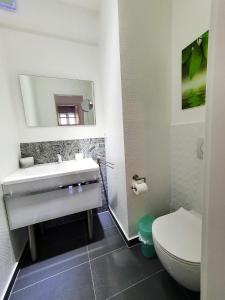 a bathroom with a white sink and a toilet at 1 Haus Linden Osljak in Island Osljak