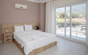 a bedroom with a large bed and a large window at Villa Raya2 in Fethiye +20 photos
