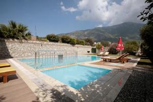 a swimming pool with a mountain in the background at Villa Raya2 in Fethiye