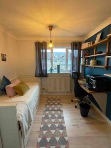 a bedroom with a bed and a desk and a window at Milan Casa in Winnersh