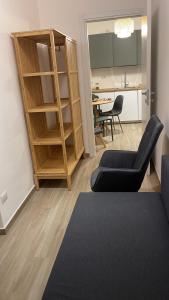 a living room with a book shelf and a table at Luni 4 - Design trilo suite -M3- 8 min dal Duomo in Milan