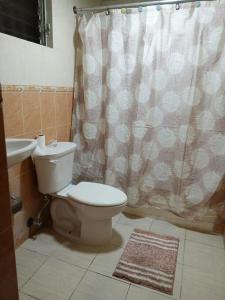 a bathroom with a toilet and a sink at Sientete como en casa. in El Seis