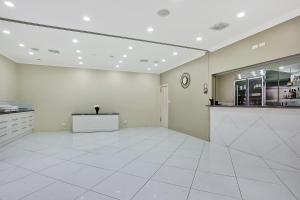 a large empty room with a kitchen and a counter at Bushman's Motor Inn in Parkes