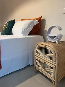 two beds with pillows and a basket in a room at Domus Orestea Luxury Suites in Palermo