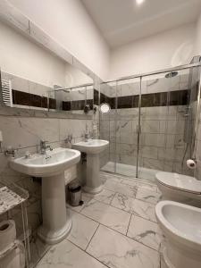 a bathroom with two sinks and a shower at Queen Meg Roma in Rome