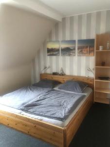 a bedroom with a wooden bed with two lamps at Holiday in Wildflecken