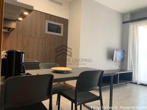 a dining room with a table and chairs at Suites Marilia Apartments - Suite Livorno Holiday Home Group in Livorno