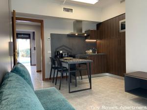 a kitchen with a table and chairs in a room at Suites Marilia Apartments - Suite Livorno Holiday Home Group in Livorno