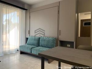 a living room with a couch and a table at Suites Marilia Apartments - Suite Livorno Holiday Home Group in Livorno