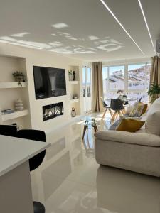 a living room with a couch and a tv at Luxury Bonanza in Benalmádena
