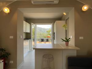 a kitchen with a island in the middle of a room at Mare E Monti Di Simonetta in Spotorno