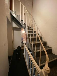 a staircase in a room with a stair case at Residence Montlosier in Le Mont-Dore