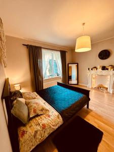 a bedroom with a bed and a large window at Ikšķiles apartamenti in Ikšķile