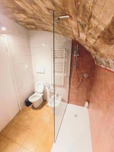 a bathroom with a toilet and a glass shower at Trastevere in Music in Rome