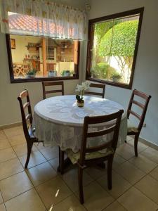 a dining room table and chairs with a table and a window at Hermosa casa amplia en zona residencial in Santa Cruz de la Sierra