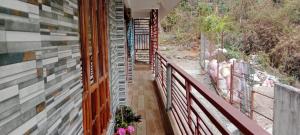 een balkon van een huis met bloemen erop bij Happy Morning Rohini Homestay in Kurseong