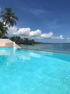 a swimming pool with a view of the ocean at Eden Blue in Sainte-Anne