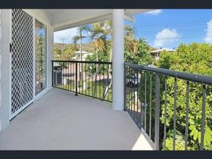 a balcony of a home with a view of the ocean at Apartment on Henry in North Ward