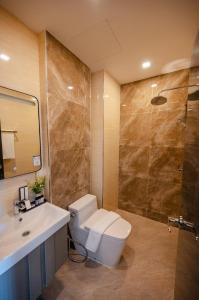 y baño con aseo, lavabo y ducha. en Bestier Hotel Hatyai, en Hat Yai