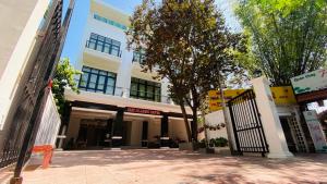 a white building with a gate in front of it at Hue Classic Hotel in Hue