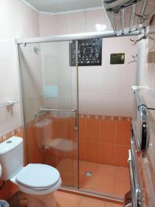 a bathroom with a toilet and a glass shower at Sarbon Plaza Hotel in Bukhara +35 photos