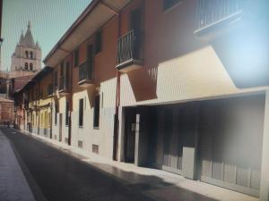 an empty street with buildings and a church at Estudio Paloma in León